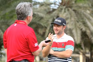 A delighted Andy Sullivan chatting to GM's Jezz Ellwood on the range in Abu Dhabi