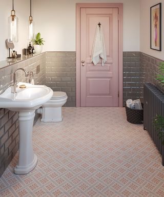 Pink and grey bathroom scheme with pink patterned floor tiles and pink door