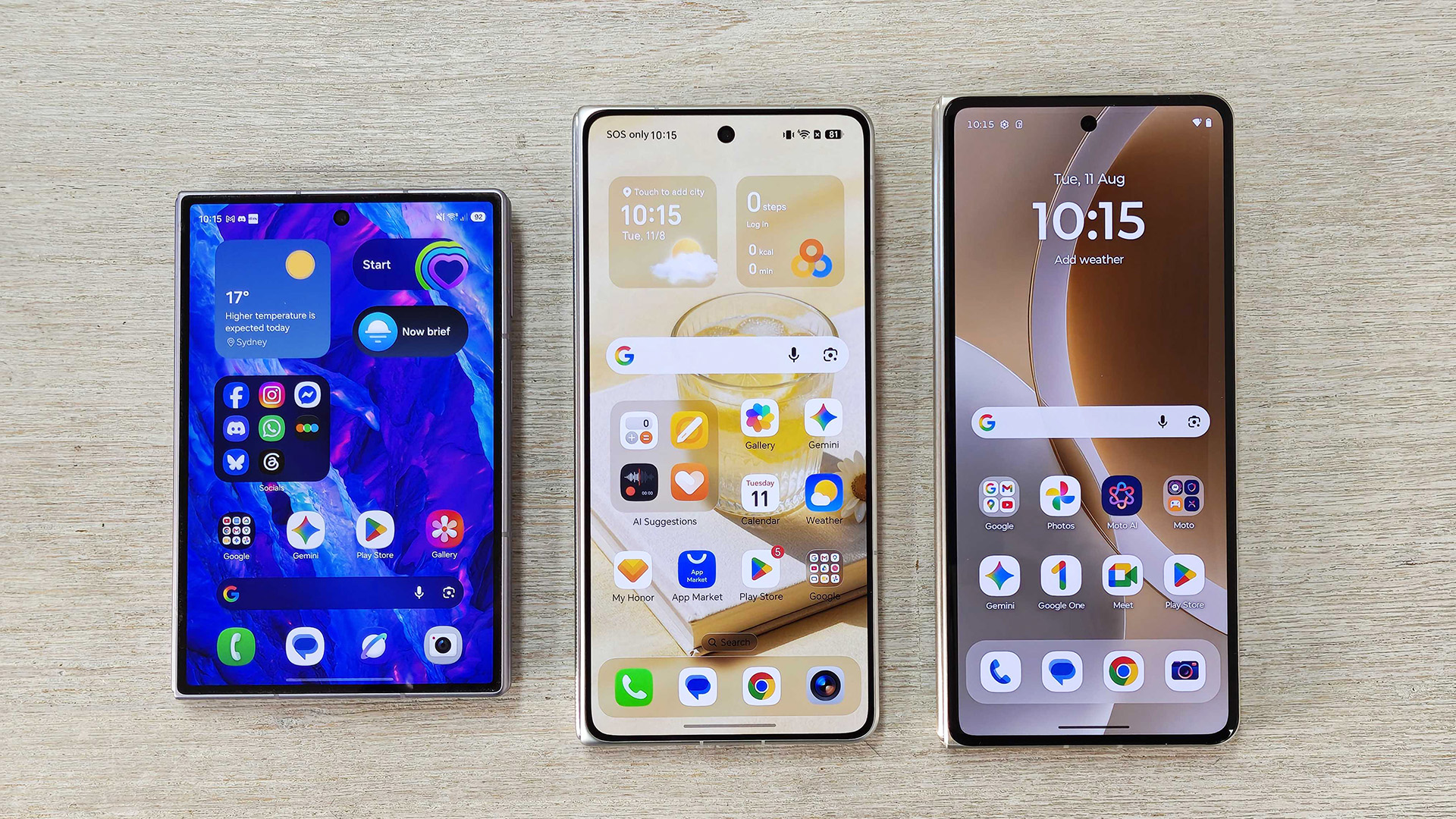 Three foldables, Samsung Galaxy Z Fold 8, Honor Magic V6 and Motorola Razr Fold on a desk.
