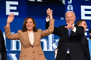 US President Joe Biden holds US Vice President and 2024 Democratic presidential candidate Kamala Harris hand after delivering the keynote address on the first day of the Democratic National Convention (DNC) at the United Center in Chicago, Illinois, on August 19, 2024. Vice President Kamala Harris will formally accept the party's nomination for president at the DNC which runs from August 19-22 in Chicago