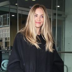 Michelle Randolph wearing a black coat, jeans, and pumps in NYC