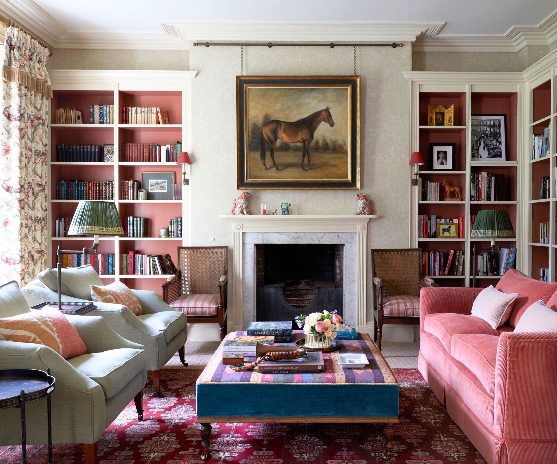 Classic English formal living room decorated in the English country style with armchairs from David Seyfried and built-in book shelves