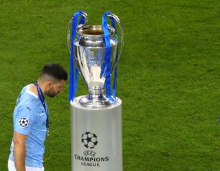 Sergio Aguero looks dejected as he walks past the Champions League trophy following Manchester City's loss to Chelsea in the 2021 final.