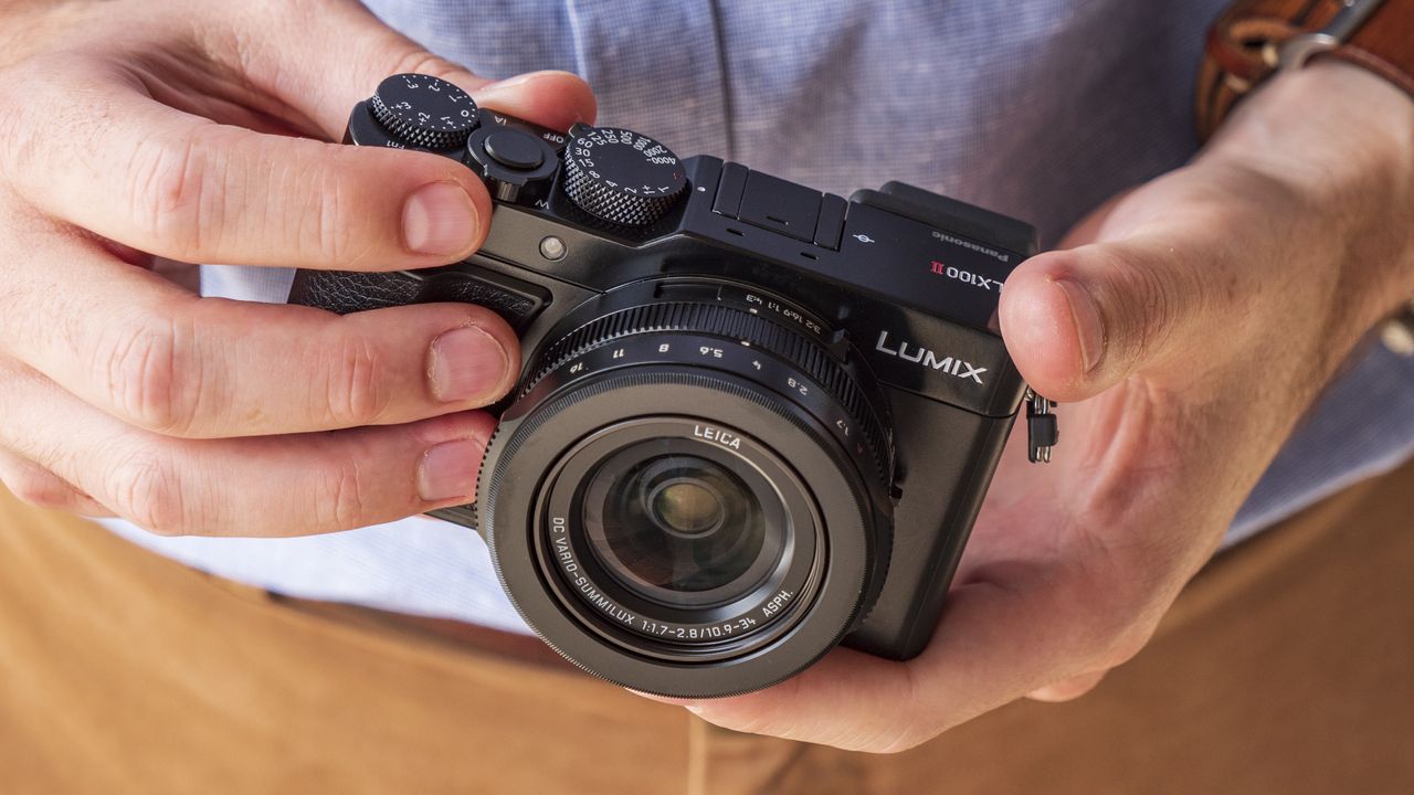 Panasonic Lumix LX100 II compact camera in the hand