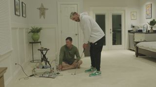 Full Swing shot of Brooks Koepka putting on his carpet at home