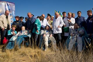 Expedition 28 Commander Andrey Borisenko, left, Flight Engineers Alexander Samokutyaev, center, and Ron Garan, sit in chairs outside the Soyuz Capsule just minutes after they landed in a remote area outside the town of Zhezkazgan, Kazakhstan, on Friday, S