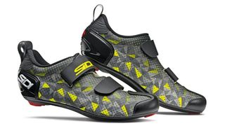 A silver, black and yellow pair of Sidi triathlon shoes on a white background