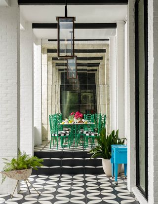 A small outdoor dining room with mirrors