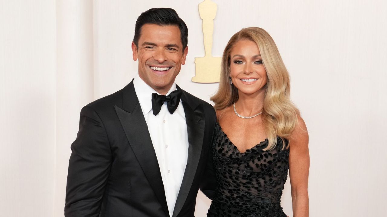 kelly ripa and mark consuelos on a white background