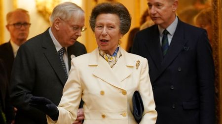 Princess Anne, wearing a white skirt suit, attends a reception celebrating exceptional individuals and organisations contributing towards humanitarian efforts across the globe at Buckingham Palace on February 20, 2025