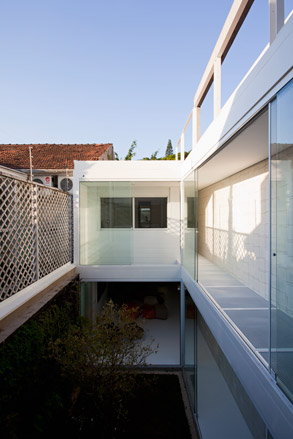 Corridor on ground level and a mesh footbridge on the first floor