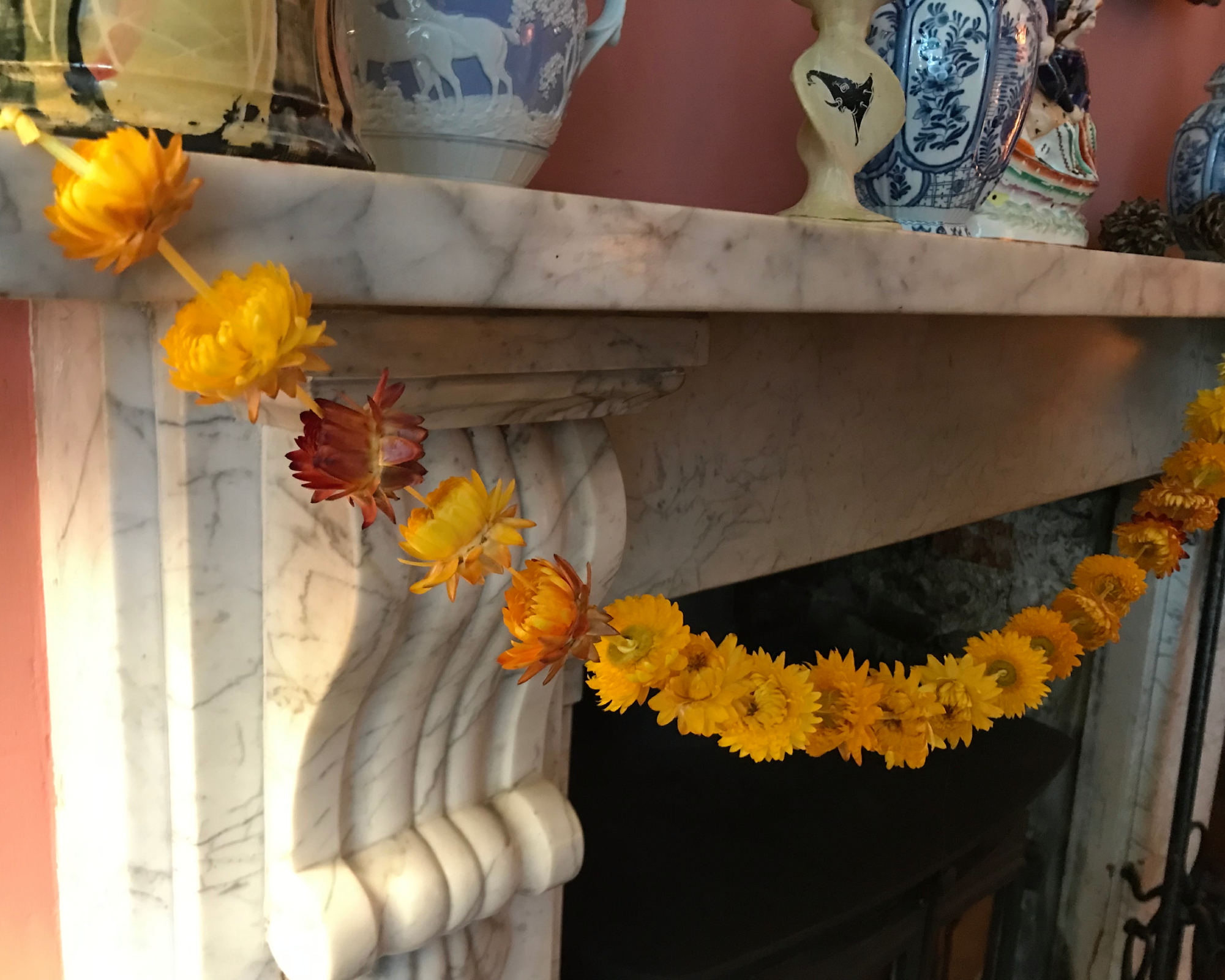 garland made of dried strawflowers hanging on a fireplace