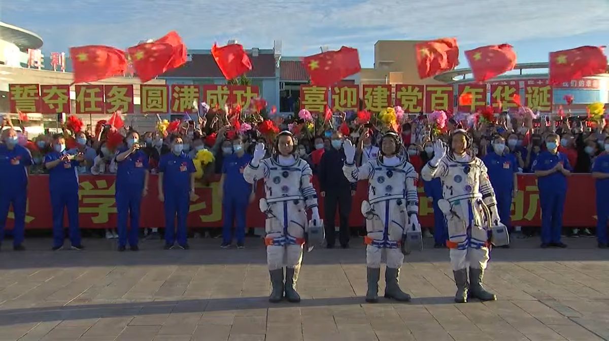 The crew of China's Shenzhou 12 mission, the first crewed flight to the country's new Tiangong space station core module Tianhe, wave farewell ahead of their launch on June 17, 2021.