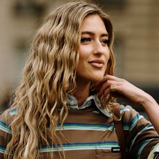 a woman with blonde wavy hair