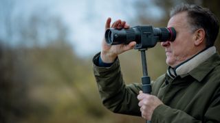 Man using Kite Optics APC 60 ED spotting scope