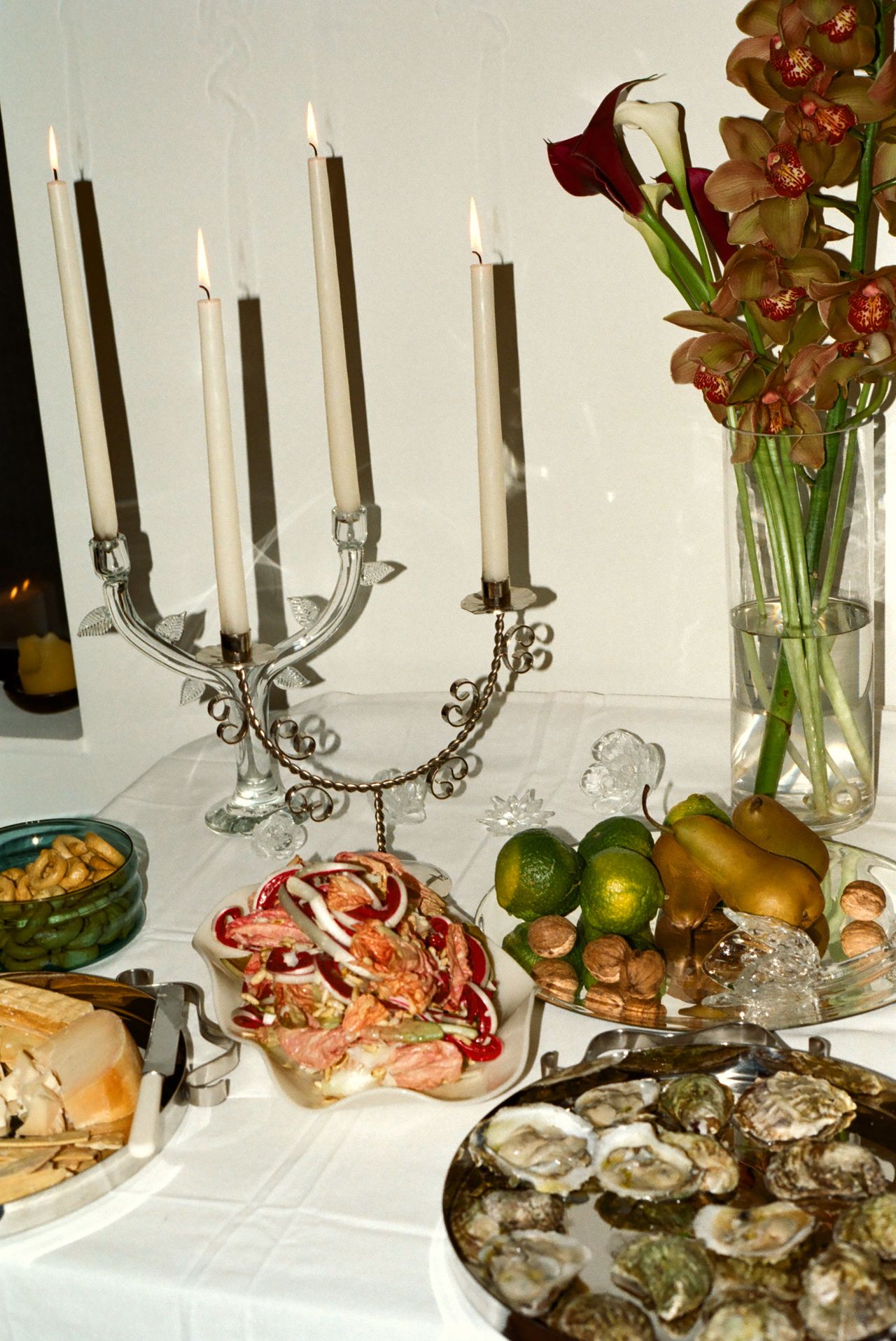 a table set with oyster and an ornate candelabra