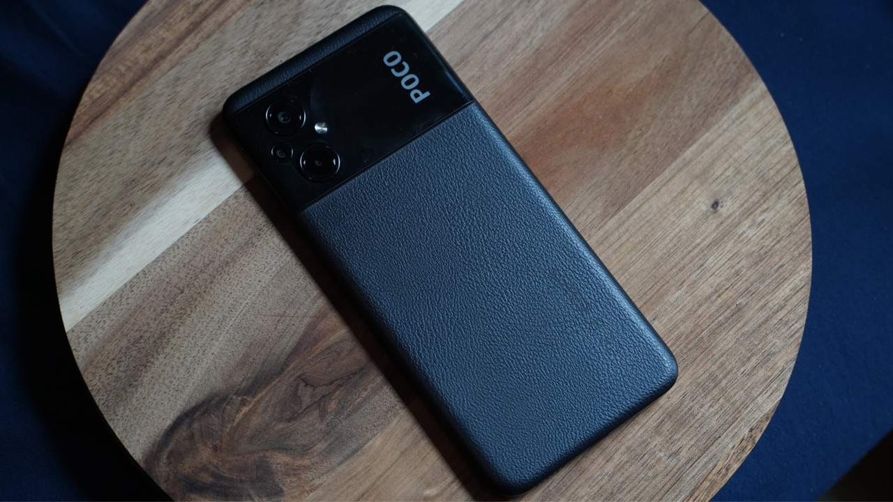 The rear of the Poco M5 smartphone is covered in a black, leather-like material.