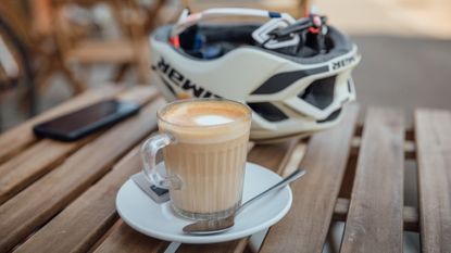 Image shows rider taking caffeine in coffee and gels on a bike ride.
