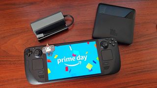 Steam Deck next to Jsaux docking station and Baseus Blade Power Bank with Prime Day logo on screen and Steam Deck mascot keychain on top.