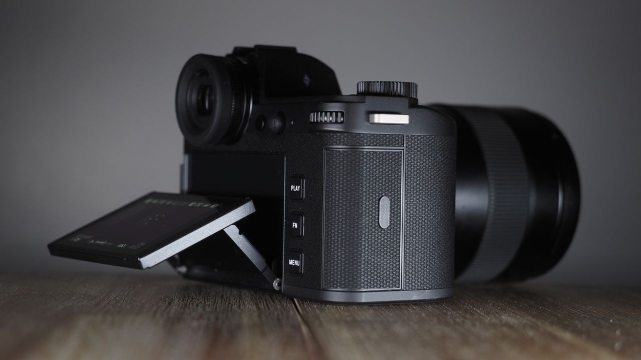 Leica SL3-S on a wooden surface with moody lighting