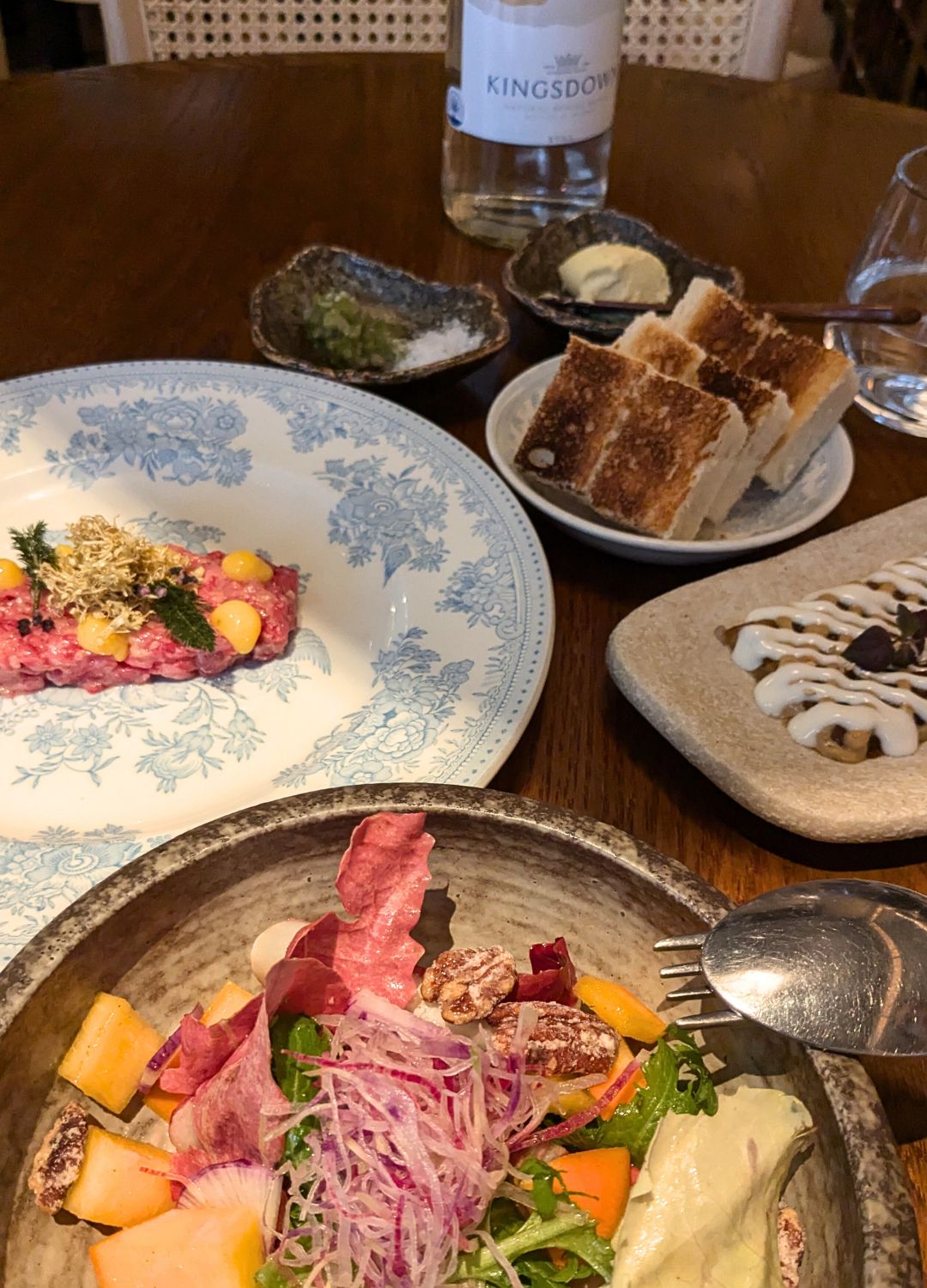 a restaurant table laid with food for one