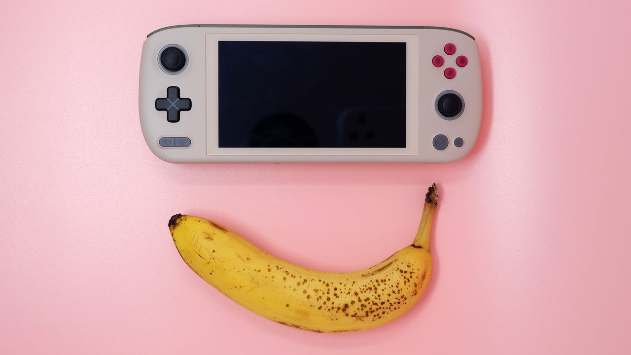 Ayaneo Air 1S handheld gaming PC on a pink background.