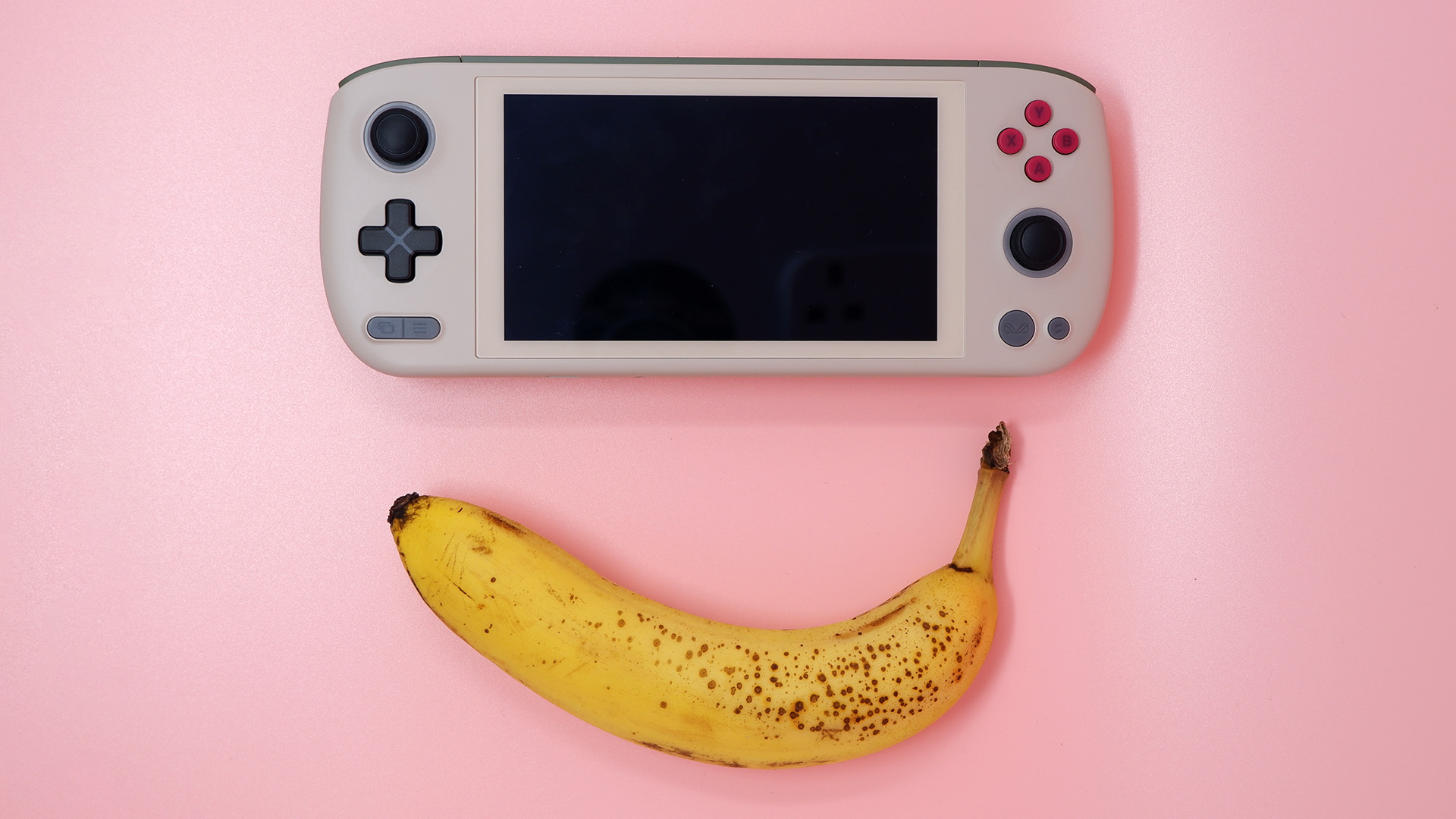 Ayaneo Air 1S handheld gaming PC on a pink background.