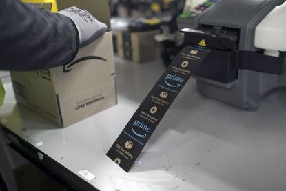Amazon warehouse worker printing labels for a package