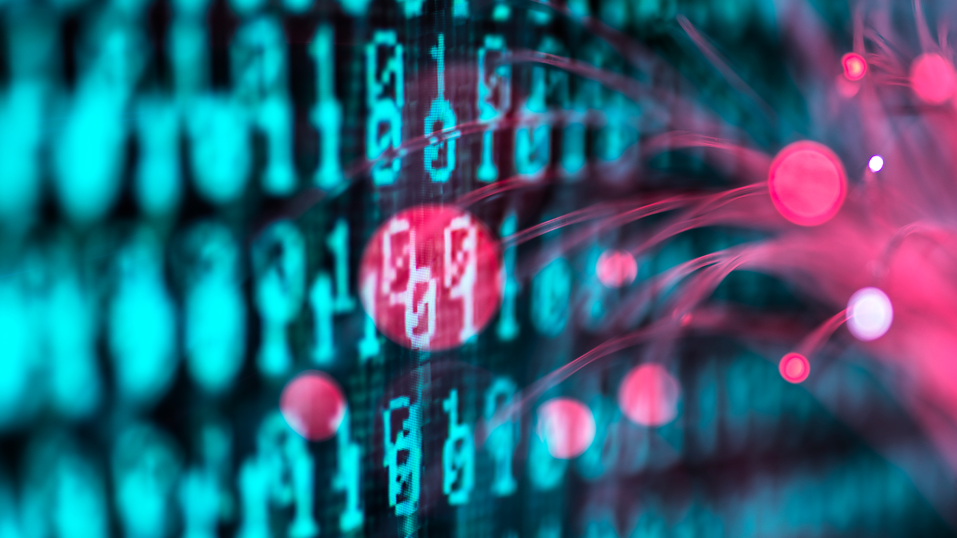 Red glowing fiber optic cables touching a screen with computer source code and highlighting code snippet in red. 