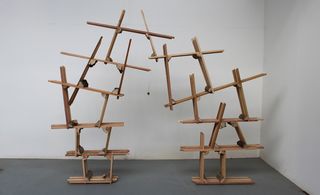 Two side by side connected wooden tower structures.