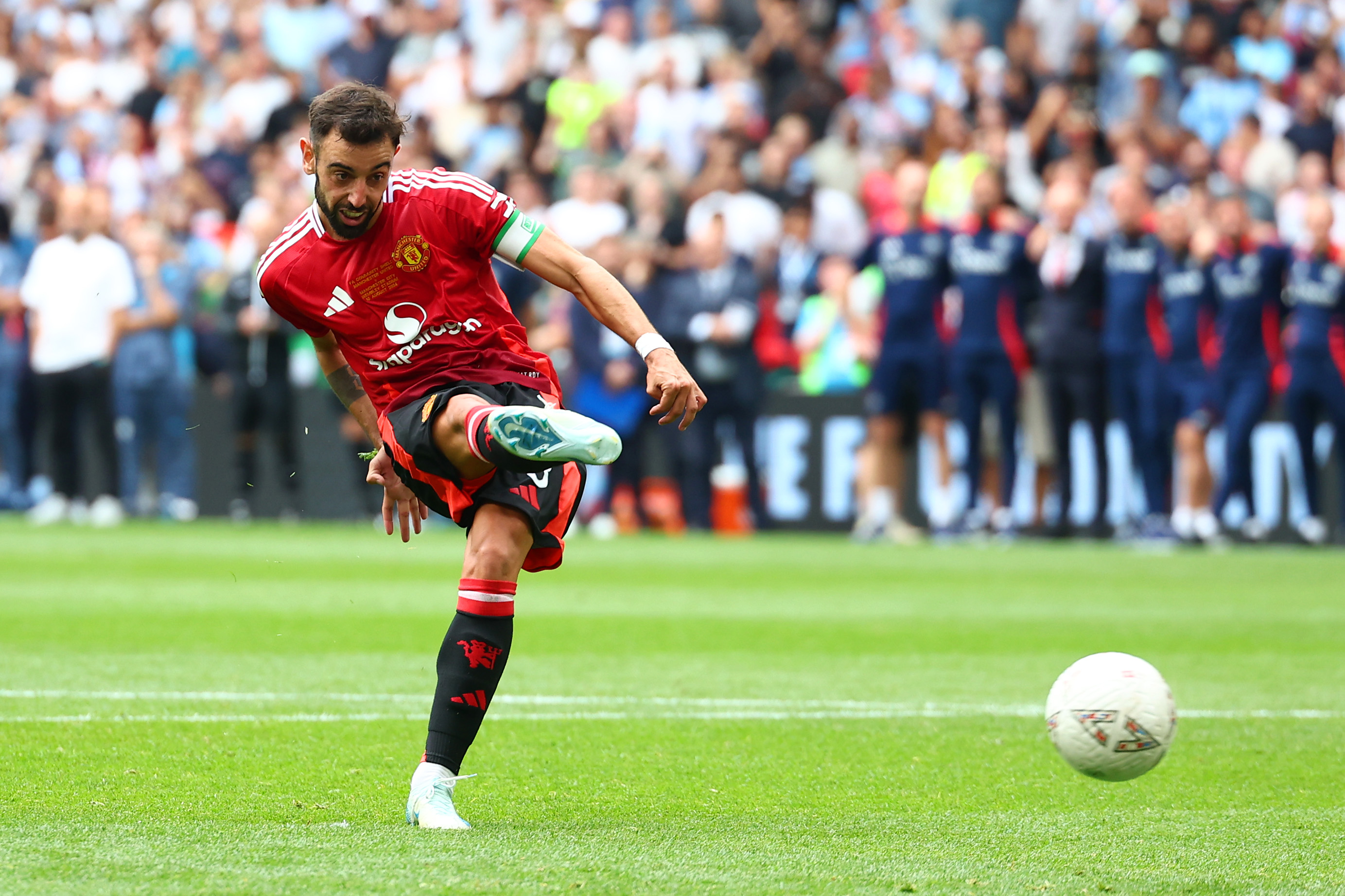 Bruno Fernandes scores a penalty in the shootout for Manchester United against Manchester City in the Community Shield in August 2024.