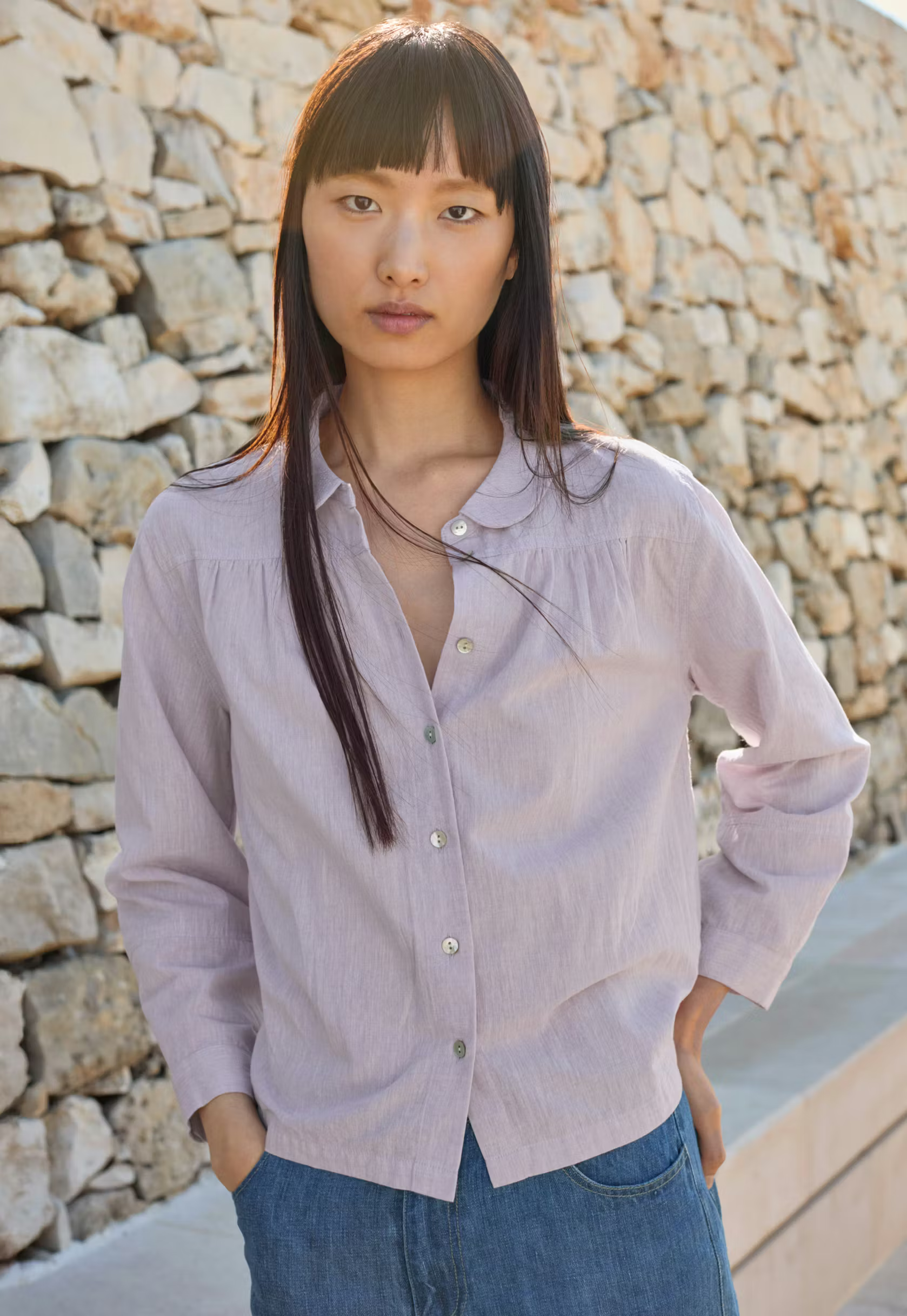 A model wearing a lilac Poetry shirt.