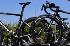 Two bikes sit on top of a team car