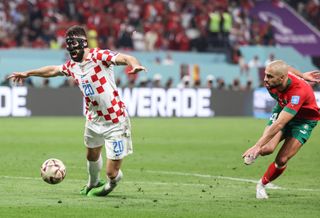 Croatia's Josko Gvardiol goes down in the area following a challenge from Morocco's Sofyan Amrabat in the sides' World Cup 2022 third-place play-off.
