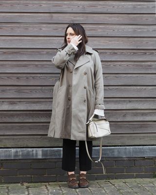 @annacascarina wearing a khaki trench coat