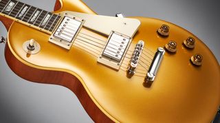 Close up of Epiphone Les Paul Standard Goldtop on grey background
