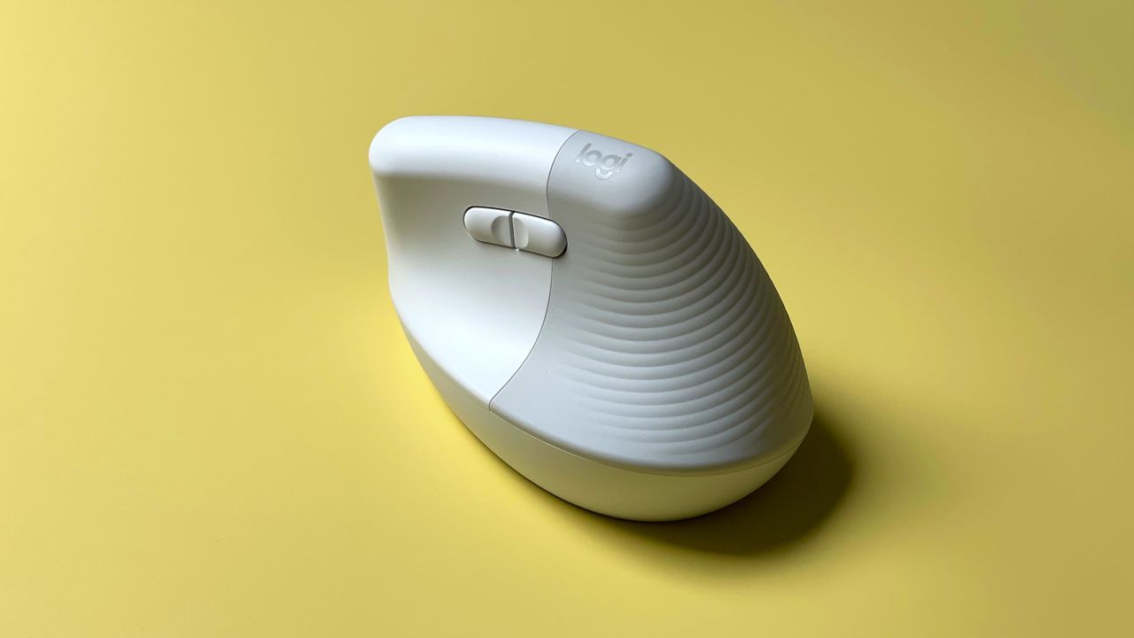The Logitech Lift for Mac mouse against a yellow background.