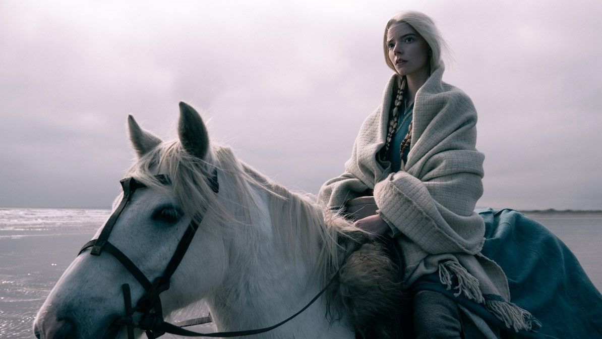 Anya Taylor-Joy riding a white horse in The Northman
