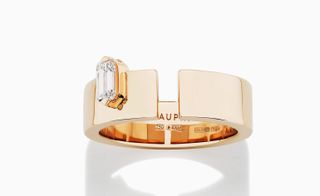 Charlotte Dauphin de la Rochefoucauld’s Ring with a rose gold thick band, off-centre placing of a rectangular diamond and a clean break in the traditional circle. .