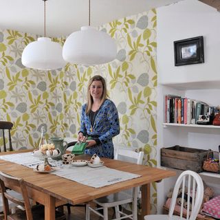 dining room with ceiling lamp and wallpaper on wall with women