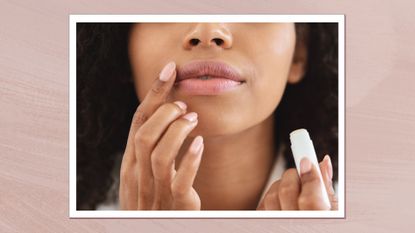 A close up of a woman applying lip balm to her lips with her finger/ in a pink textured template