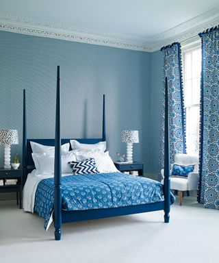 An example of bed ideas showing a blue four-poster bed in a blue bedroom
