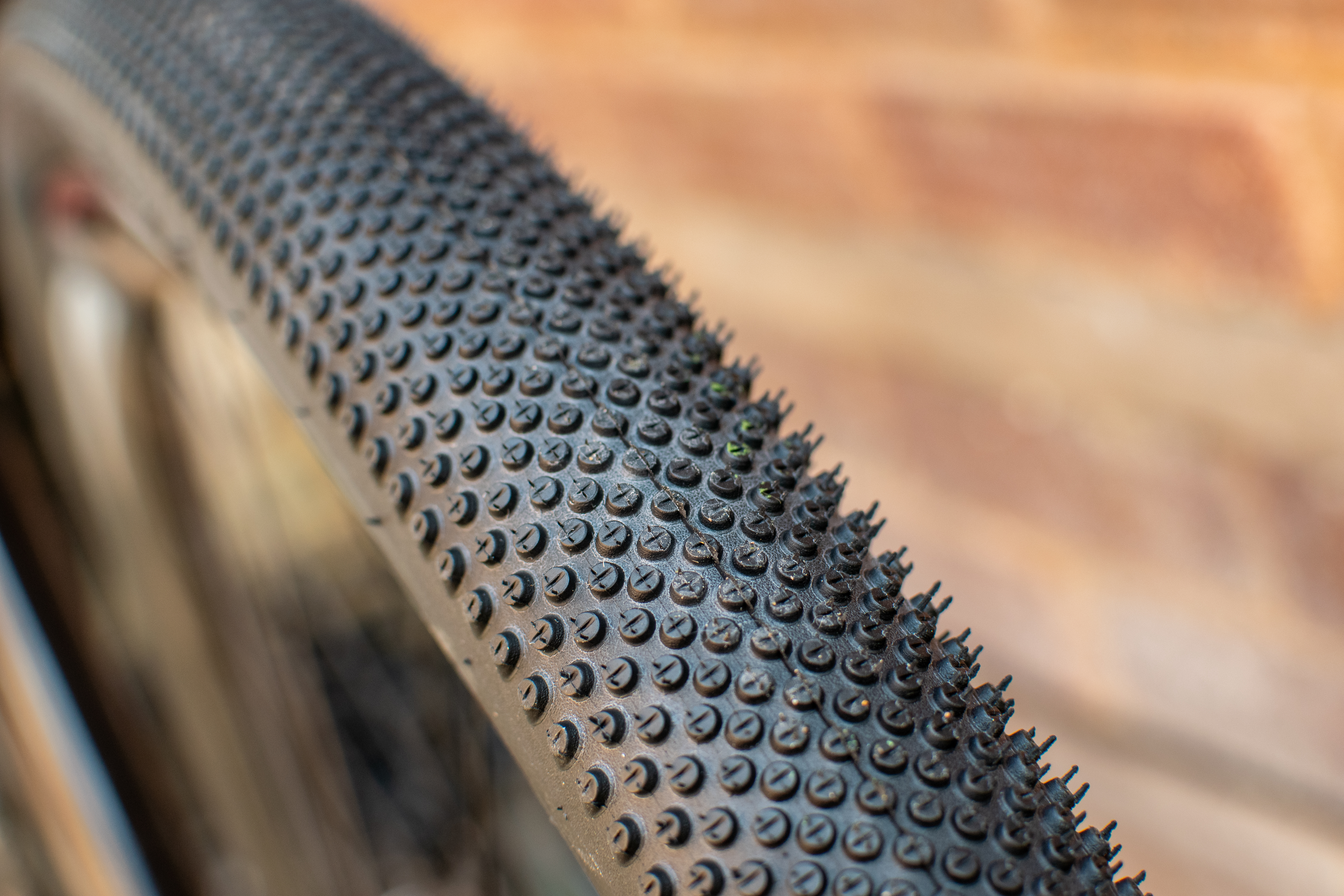 A Schwalbe G One All Round tyre in front of a brick wall
