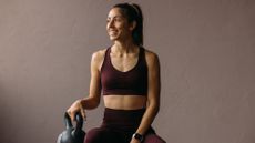 A woman in a gym with a kettlebell