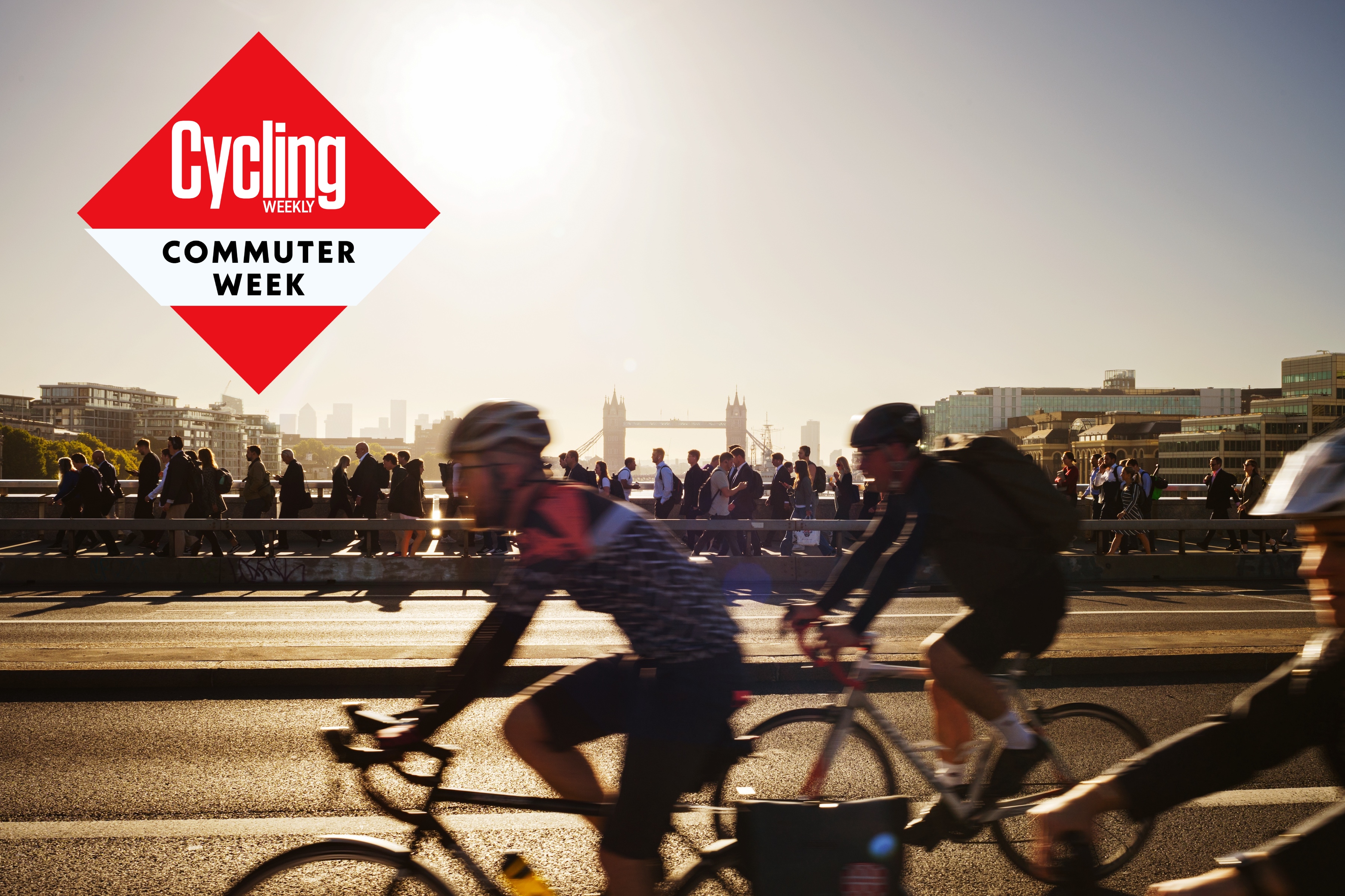 Cycle commuters in London, with Tower Bridge in the background