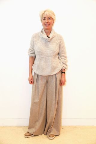 Emma Thompson wearing beige trousers and an oversized jumper