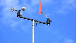 A photo of an anemometer against a blue sky