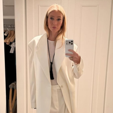 Gwenyth Paltrow wearing a white suit and onyx necklace