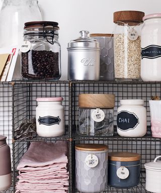 A close-up shot of metal cage storage for jars, pots and napkins