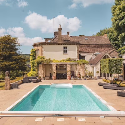 Countryside house and pool with trees and blue sky
